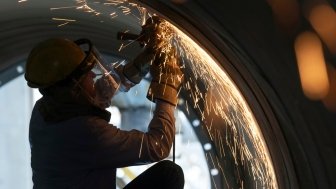 US Factory Worker Wielding Pipe